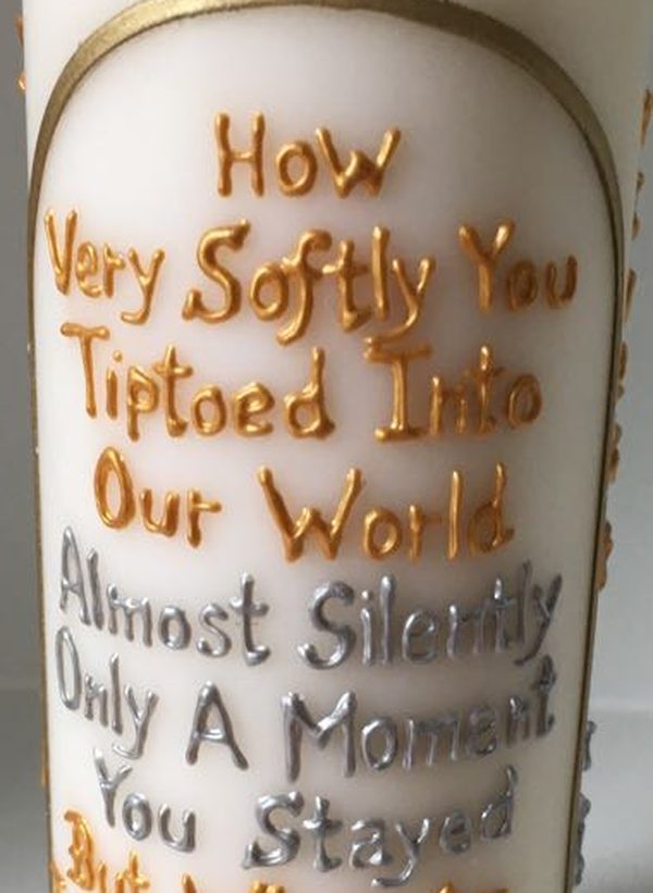 Close-up of hand-lettered words on a candle