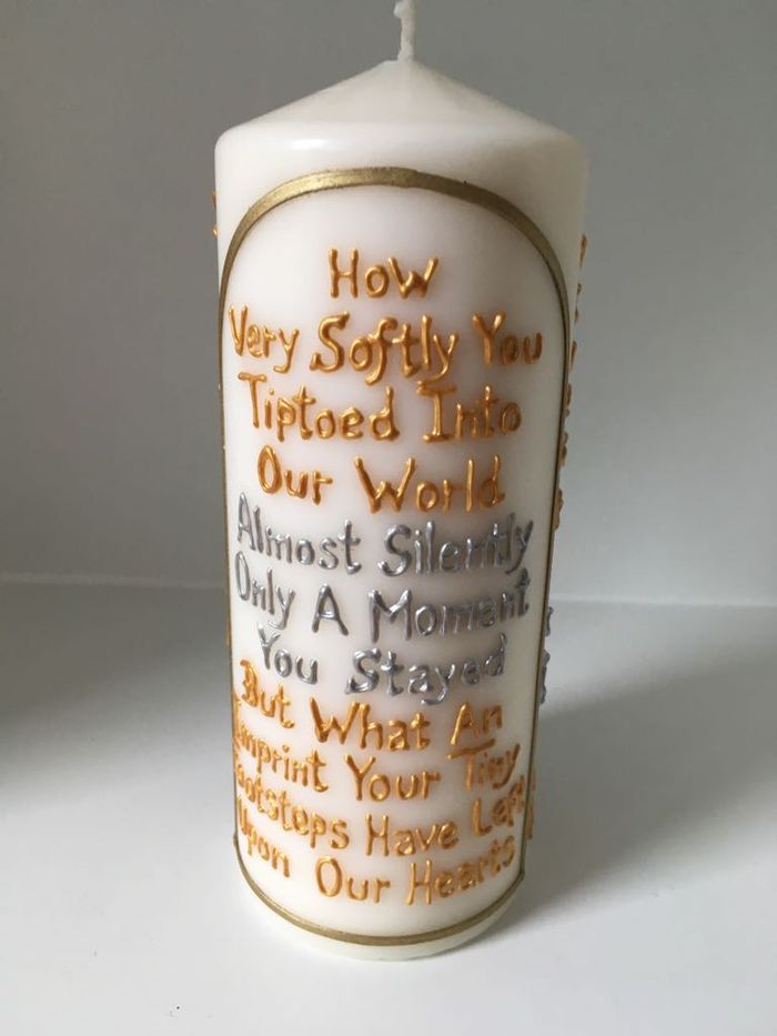 Candle lettered: How very softly you tiptoed into our world